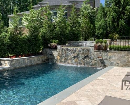 Luxury backyard pool with hot tub and waterfall