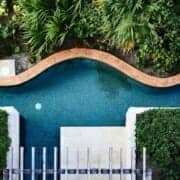A wavy luxury landscaping feature pool with greenery done by the right partner in northern virginia.