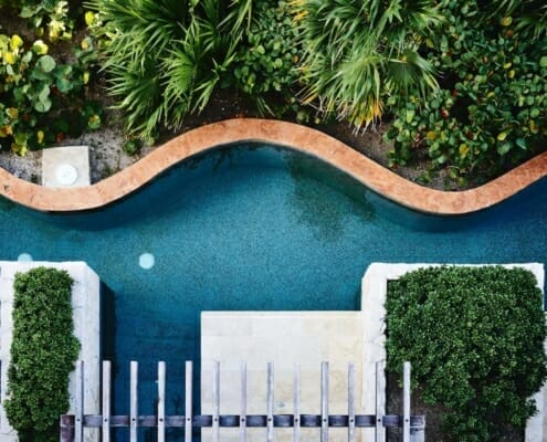 A wavy luxury landscaping feature pool with greenery done by the right partner in northern virginia.